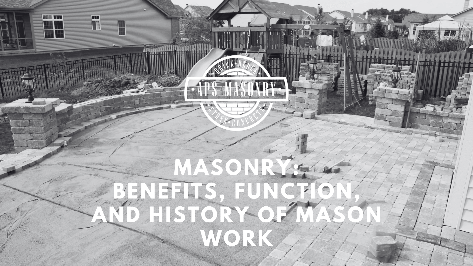 A black and white image displaying an outdoor construction site with an unfinished paving stone project, highlighting various stages of masonry work. The APS Masonry logo is central in the image with text above stating 