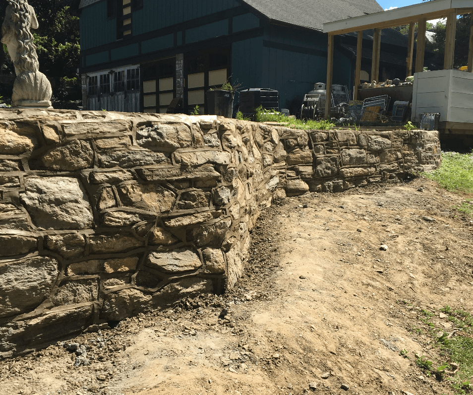 Expertly crafted stone retaining wall by Main Line Masonry Contractors, showcasing intricate stonework and durability