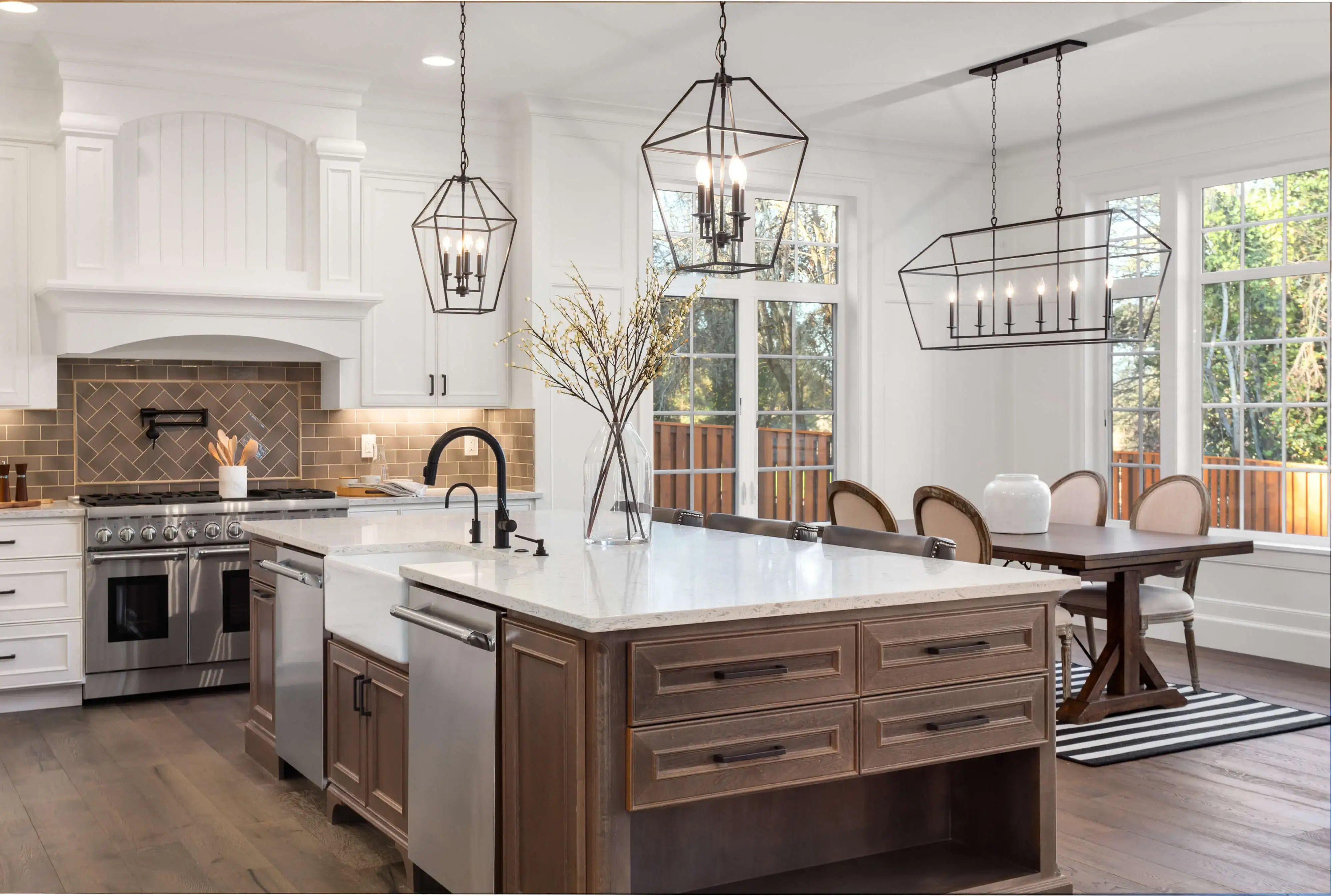Modern kitchen remodel in Philadelphia featuring a large island, stainless steel appliances, and elegant pendant lighting