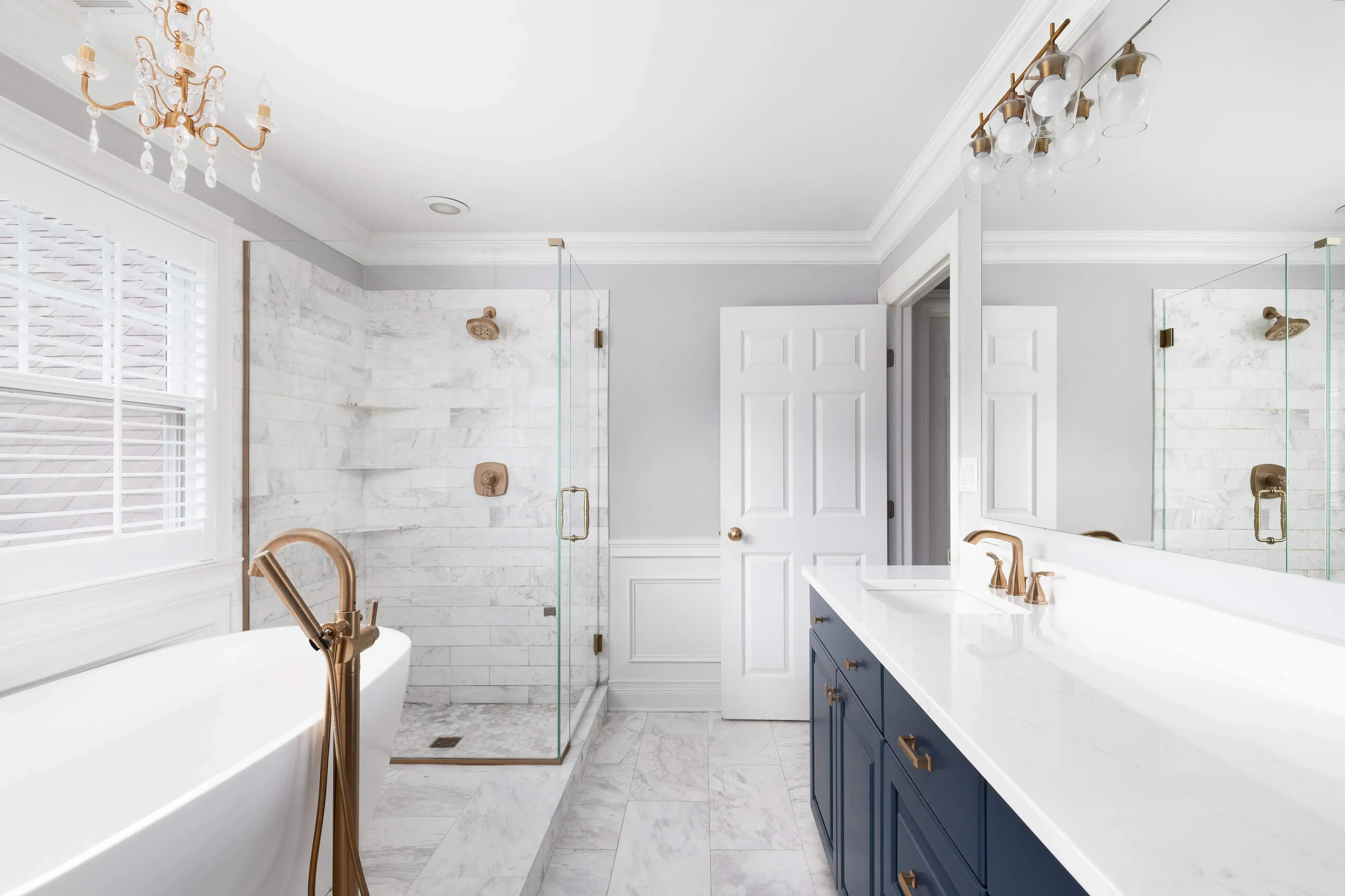 Elegant bathroom remodel in a Philadelphia home featuring a modern bathtub, glass-enclosed shower, and double vanity.